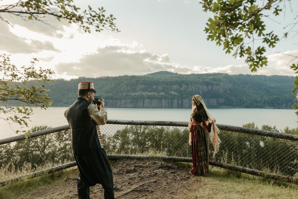 Syrian and Palestinian couple taking Super8 vintage footage of themselves during engagement photos in the Columbia River Gorge