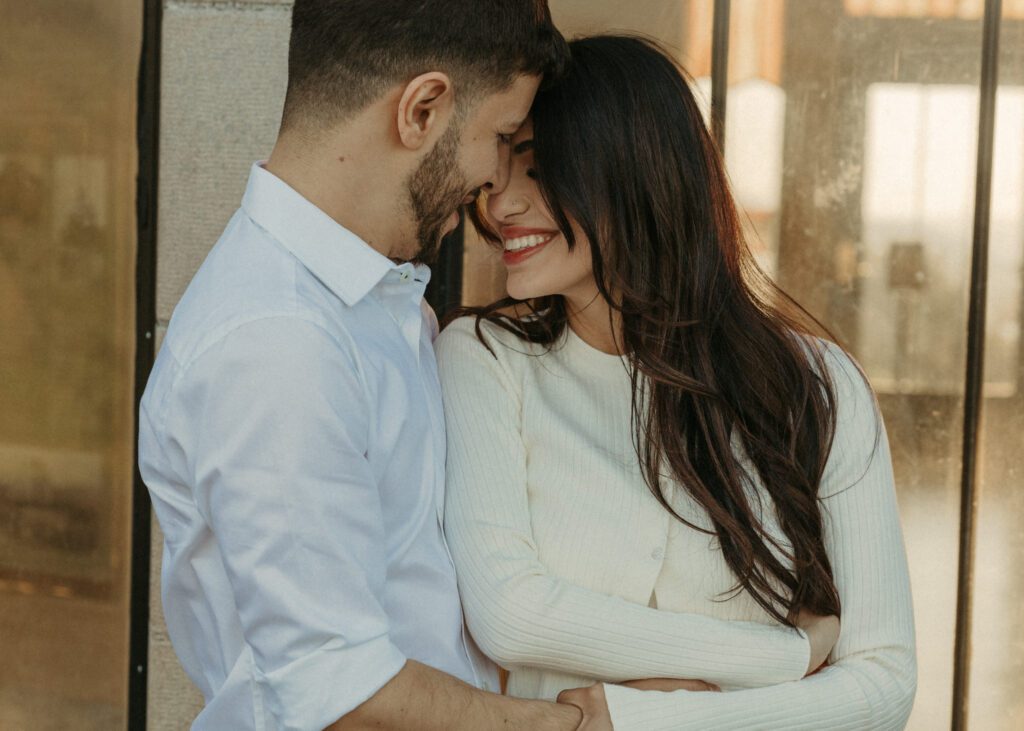 Candid and documentary golden hour engagement photos in the Columbia River Gorge, Oregon from the Vista House. Couple wears classic modern outfits