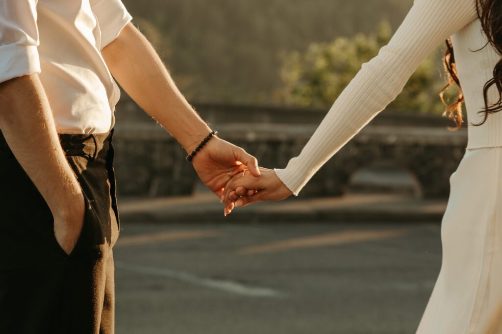 Candid and documentary golden hour engagement photos in the Columbia River Gorge, Oregon from the Vista House. Couple wears classic modern outfits