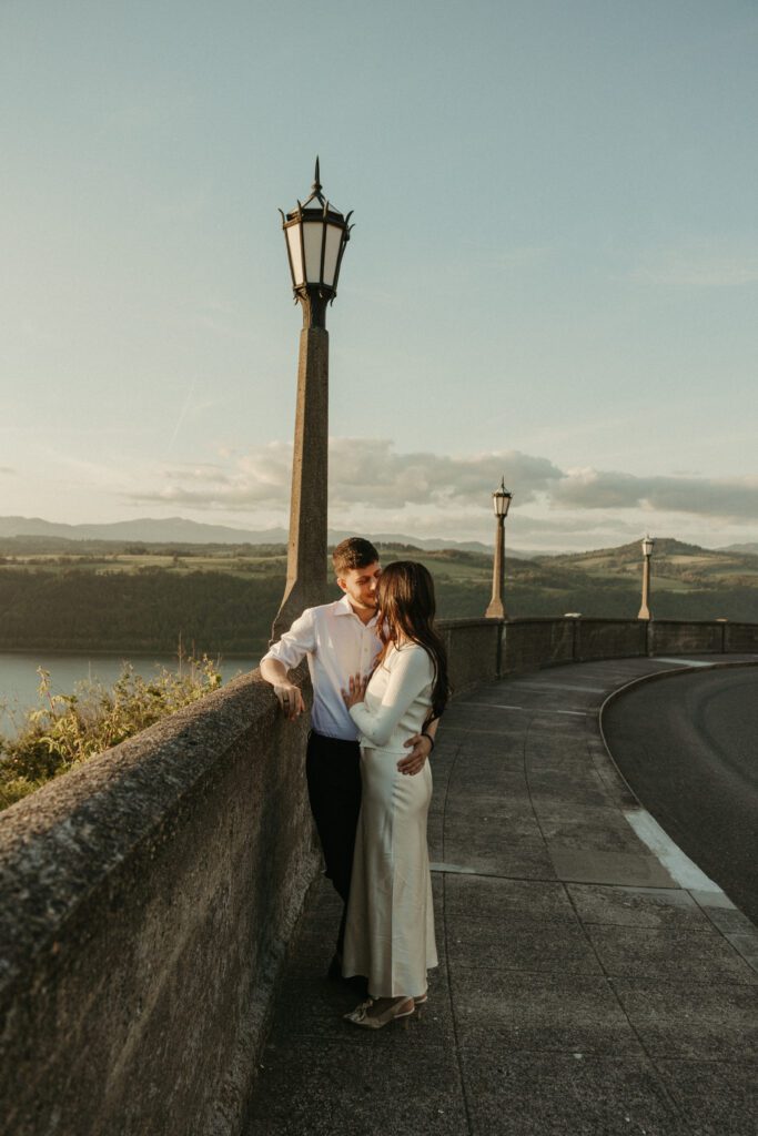 Candid and documentary golden hour engagement photos in the Columbia River Gorge, Oregon. Couple wears classic modern outfits