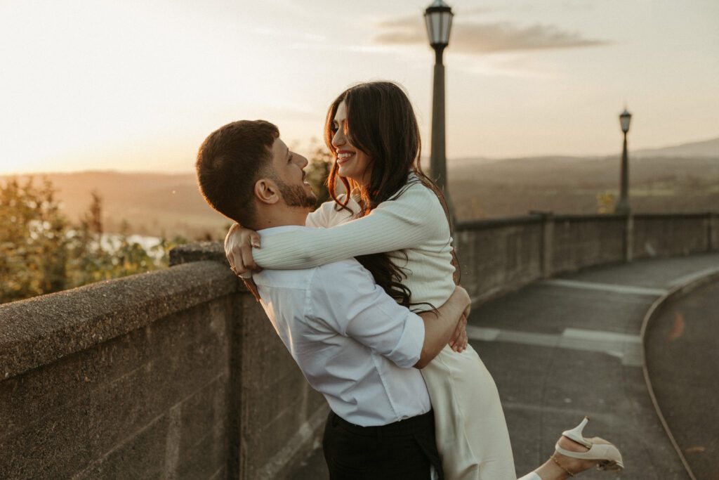 Engaged couple dancing in the sunset at the Vista House viewpoint