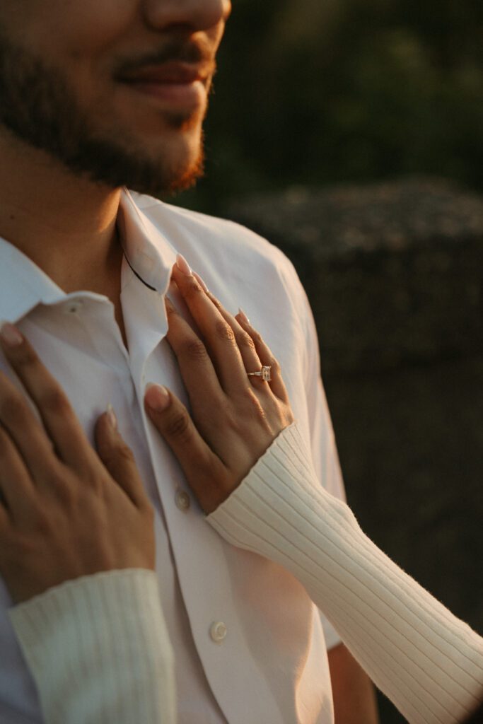 Golden sunset light catches a newly engaged couple's ring in the Columbia River Gorge, Oregon